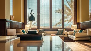 A spacious living area with a large window, a sofa set, and a coffee table. - Ramada by Wyndham Chenzhou Dongjiang Lake (Chenzhou)