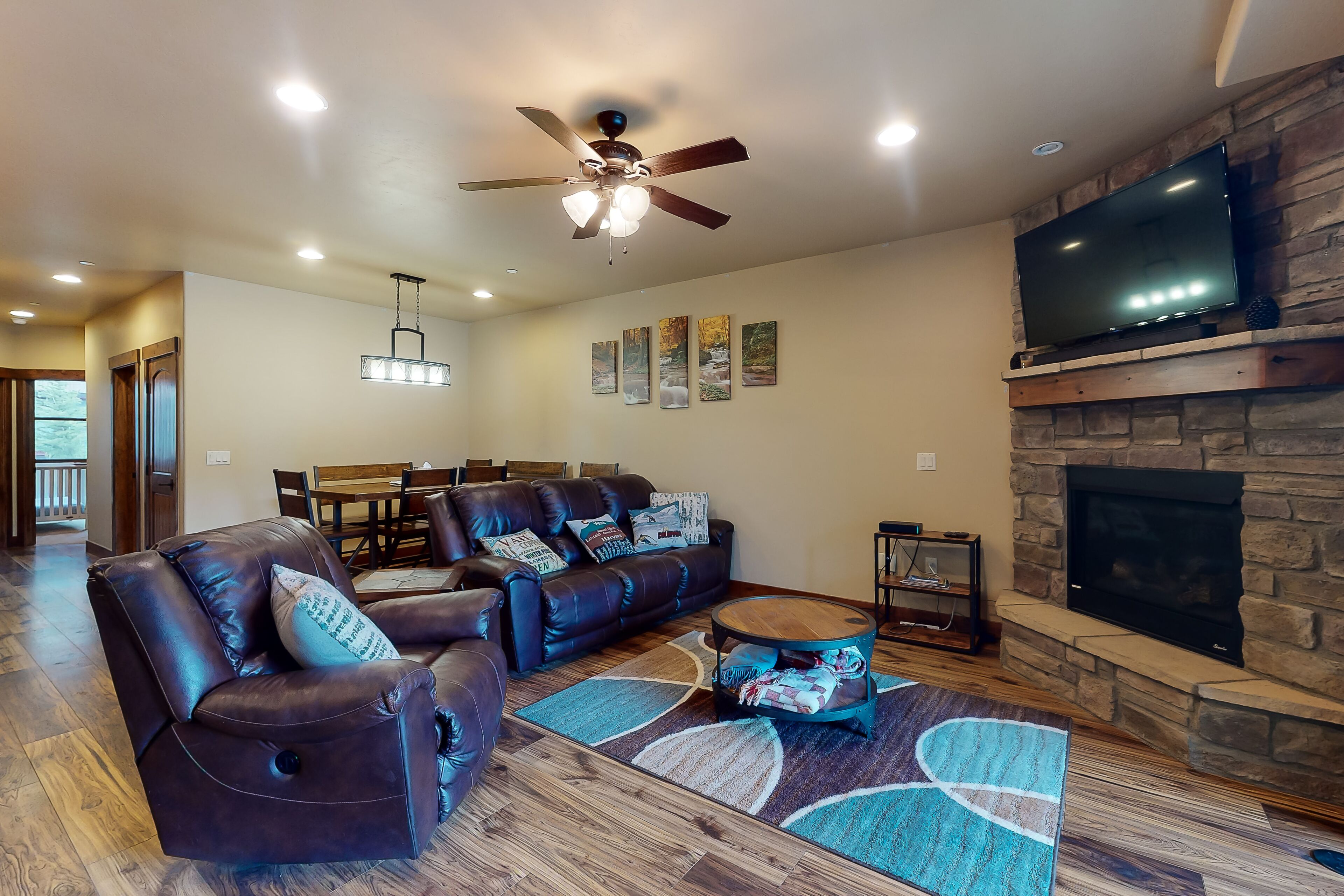 Sunny riverfront getaway with mountain views, private hot tub, & large patio