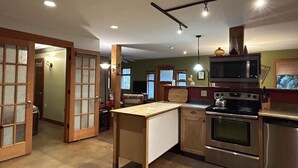 A kitchen with wooden cabinets, a stainless steel stove, and a microwave.