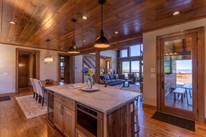 A spacious kitchen with a large island, wooden ceiling, and pendant lighting. - Ridgeline View- 4bed 3 and a half bath home with long range views, outdoor fireplace, firepit (Banner Elk)