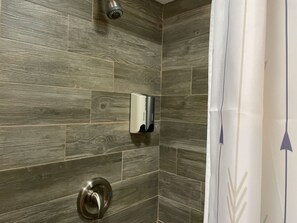 Bathtub, hair dryer, towels, shampoo