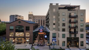 A multi-story hotel with a prominent 'Gordon Hotel' sign, a 'Nike' store, and a '5th Avenue' entrance. - The Gordon Hotel (Eugene)