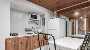A compact kitchen with a microwave, stove, and refrigerator. - Mountain Chalet with Sea Views & Pool (Moya)