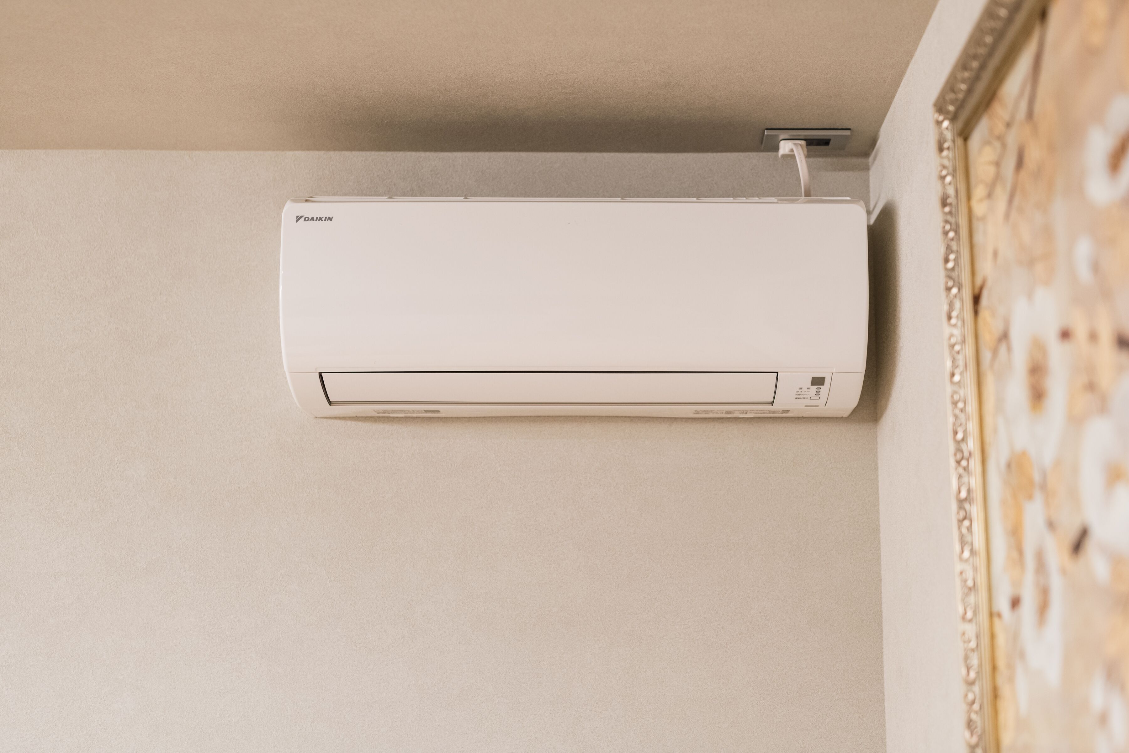 A white Daikin air conditioner mounted on a wall.
