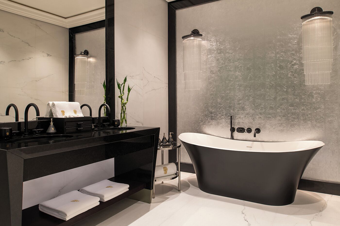 A modern bathroom with a freestanding bathtub, a vanity with a mirror, and a wall-mounted shower.