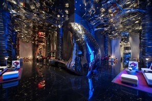A luxurious hotel lobby with a large reflective sculpture, plush seating, and modern decor. - Banyan Tree Doha at La Cigale Mushaireb (Doha)