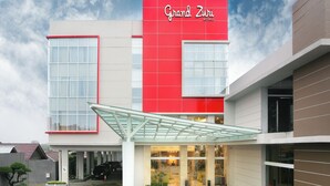 A Grand Zuri hotel with a modern facade, large windows, and a covered entrance area. - The MELIO Enim (Muara Enim)