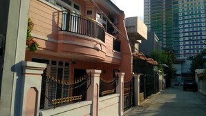 A residential building with a balcony, a gated entrance, and a street view. - Katalia Tomang (Jakarta)