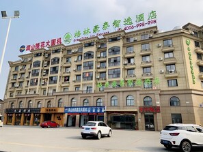 A multi-story hotel building with signage for 'Green Tree Inn Express' and 'Green Tree Inn'. - Greentree Inn Jiaxin Puyuan Kaixuan Road (Jiaxing)