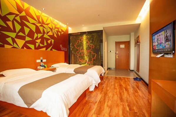 A hotel room with two beds, a TV, and a mural on the wall. - Vatica Jieshou City New Passenger Transport Center Hotel (Fuyang)