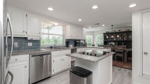 A modern kitchen with white cabinets, stainless steel appliances, and a central island. - 3Kingbeds/Fireplace/Deck/6 Flags/Airport (Grand Prairie)