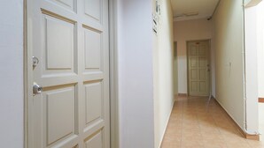 A hallway with white doors and tiled flooring. - Hotel O 9 @ Kajang Town (Kajang)