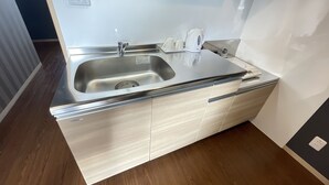 A compact kitchen with a stainless steel sink, a kettle, and a coffee maker. - BiBi Hotel Convention Bay (Ginowan)