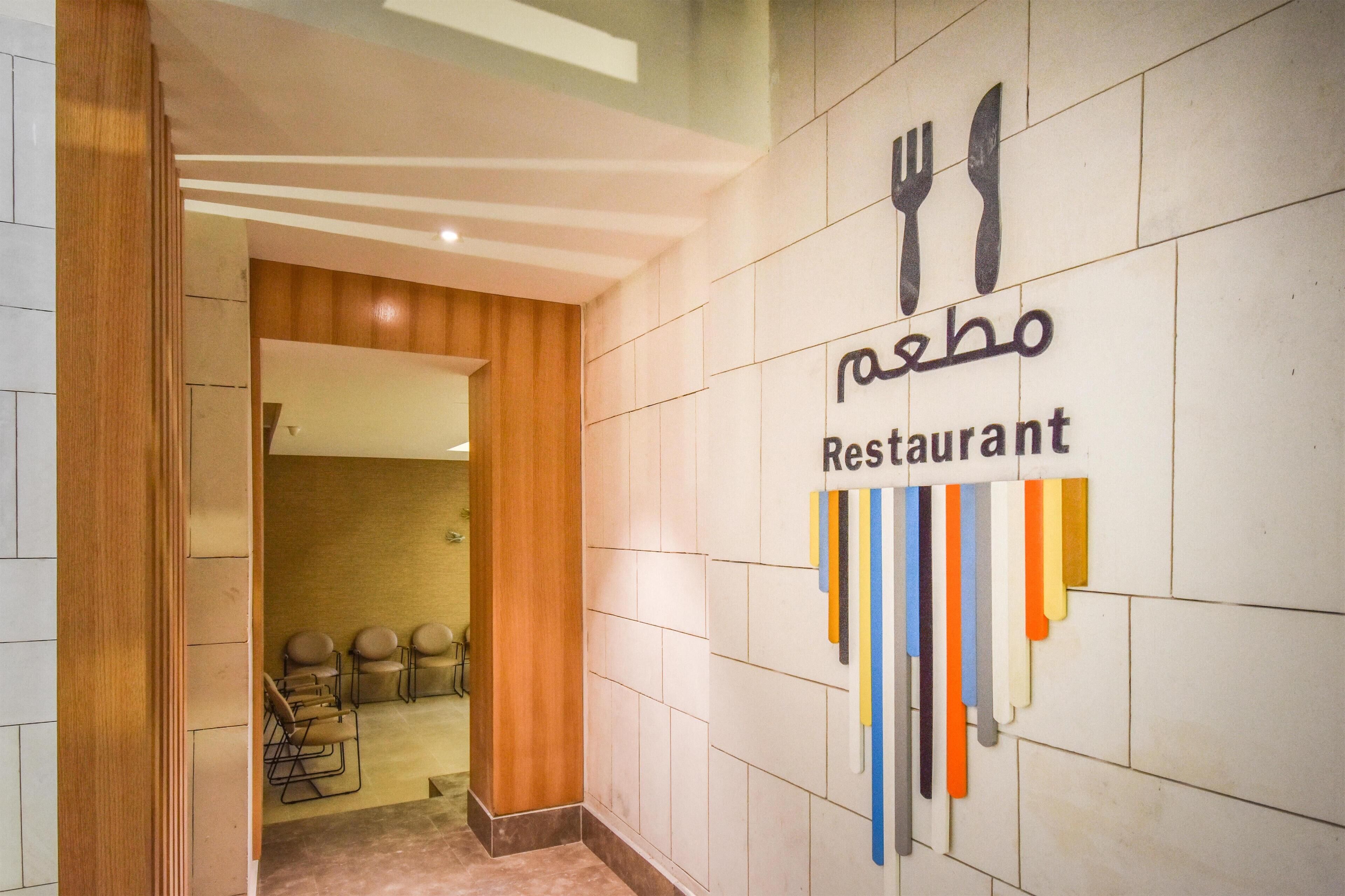 A restaurant sign with a modern design, including a fork and knife symbol and a colorful striped pattern.