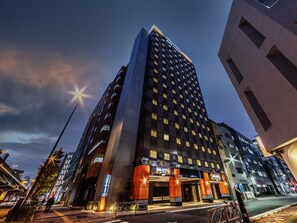 A modern hotel building with a prominent entrance, large windows, and a well-lit facade. - APA Hotel Akihabara Ekikita (Tokyo)