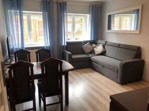 Apartamento conforto | Área de estar | TV de tela plana