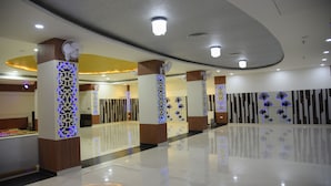 A spacious lobby with a polished floor, decorative columns, and modern ceiling lighting. - Broadway Inn (Jaipur)