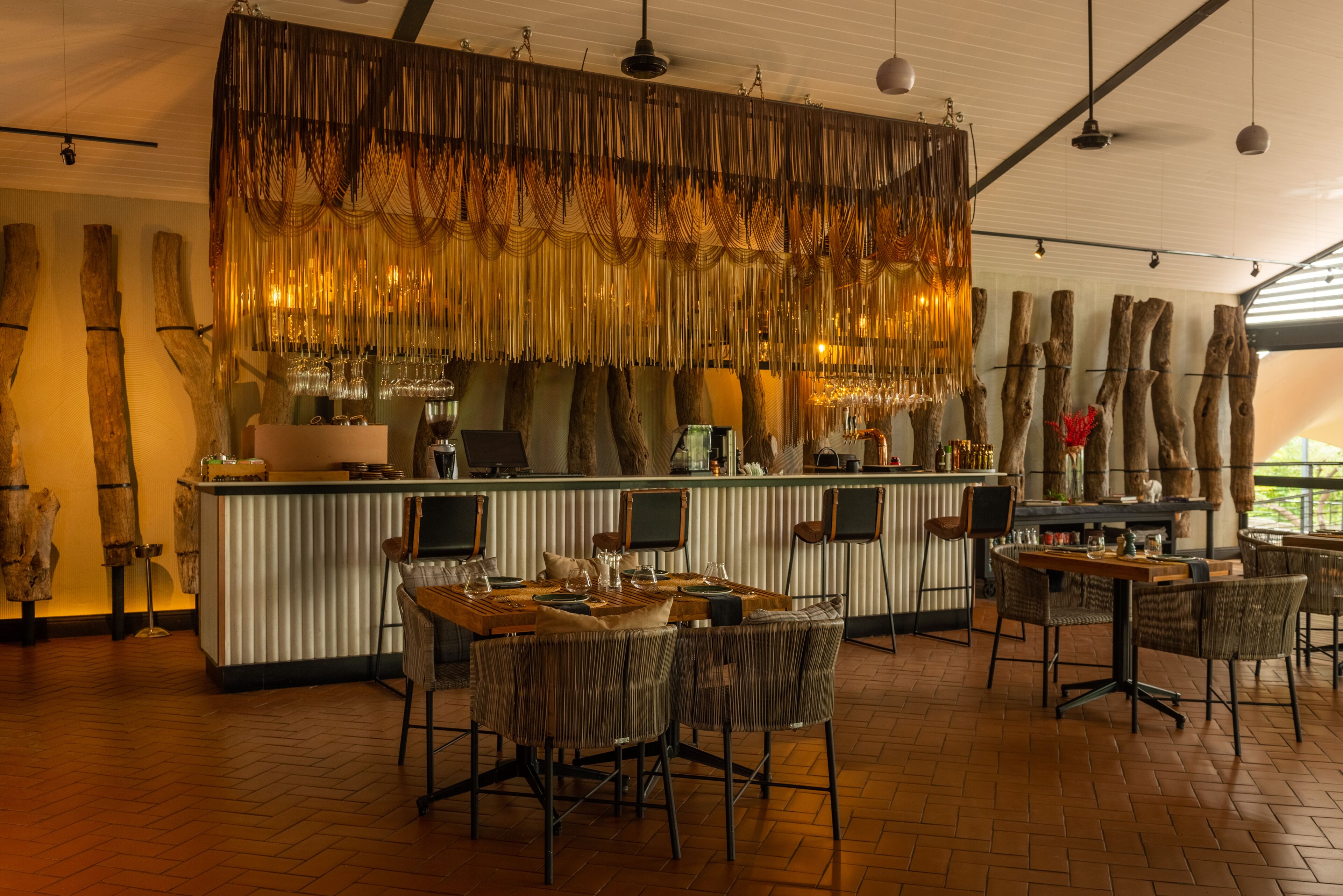 A bar area with a rustic design, featuring wooden elements and a warm ambiance.