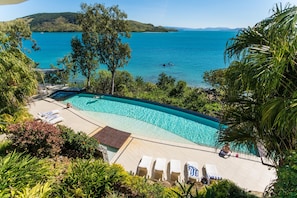 A swimming pool with a view of the sea and hills. - Edge 8 (Whitsundays)