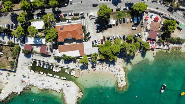 An aerial view of a coastal area with a marina, beach, and buildings. - Villa Sv Kriz (Trogir)