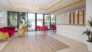 A spacious living area with a red sofa, gold chairs, and a chandelier. - Villa Sv Kriz (Trogir)