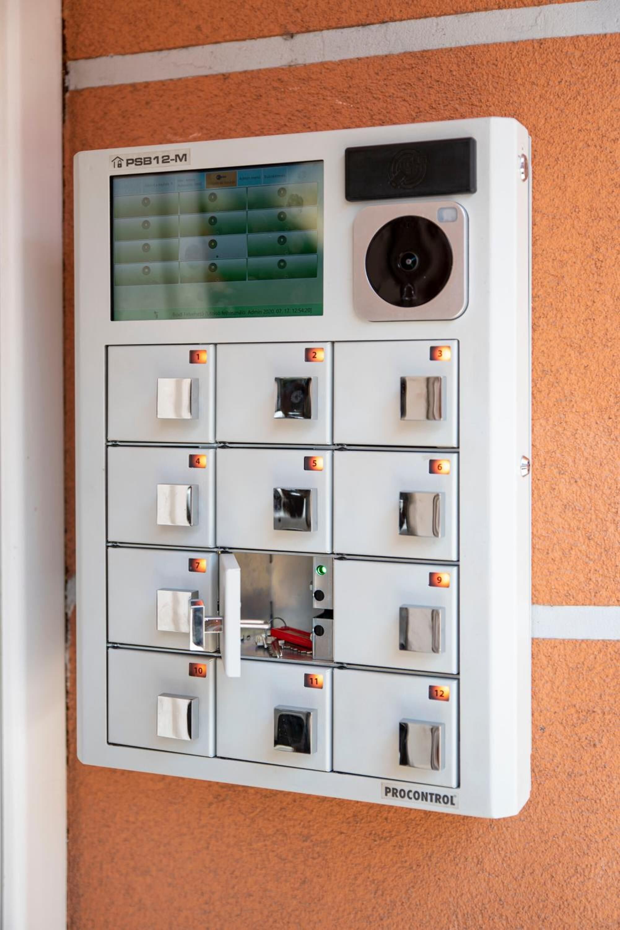 A control panel with numbered switches and a screen, likely for managing hotel room functions.