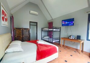 A bedroom with a bed, a desk, a TV, bunk beds, and a wardrobe. - Degung Hillside (Ciawi)