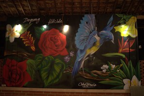 A mural with a bird, flowers, and text. - Degung Hillside (Ciawi)
