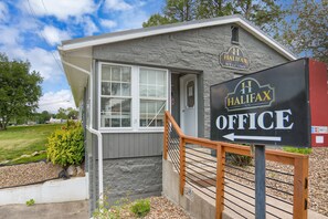 A small building with a sign reading "Halifax Office" and "Halifax Inn Welcome."