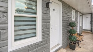 A house with a stone facade, a number 101 door, and a bench outside. - Halifax Inn (Halifax)