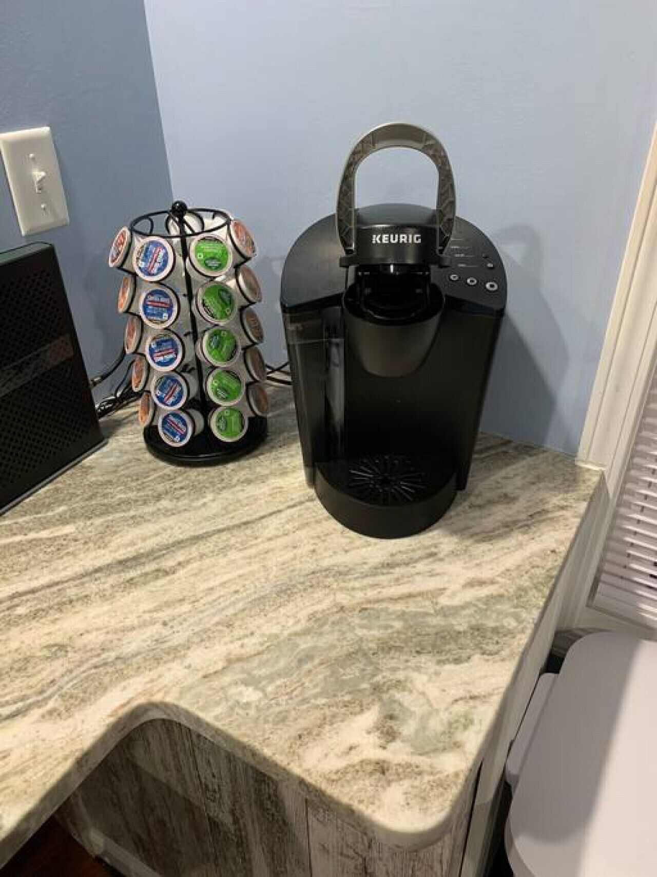 A coffee maker and a mug holder on a kitchen counter.