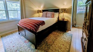 A bedroom with a bed, nightstands, a dresser, and a window with curtains. - Pet-Friendly Suite in North Georgia Mountains with Kitchen, Dining & Living Room (Dahlonega)