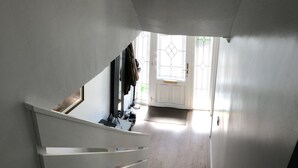 A staircase leading to a landing with a door and a window. - Limegrove-A Comfortable Home from Home-3 Bed House (Carluke)