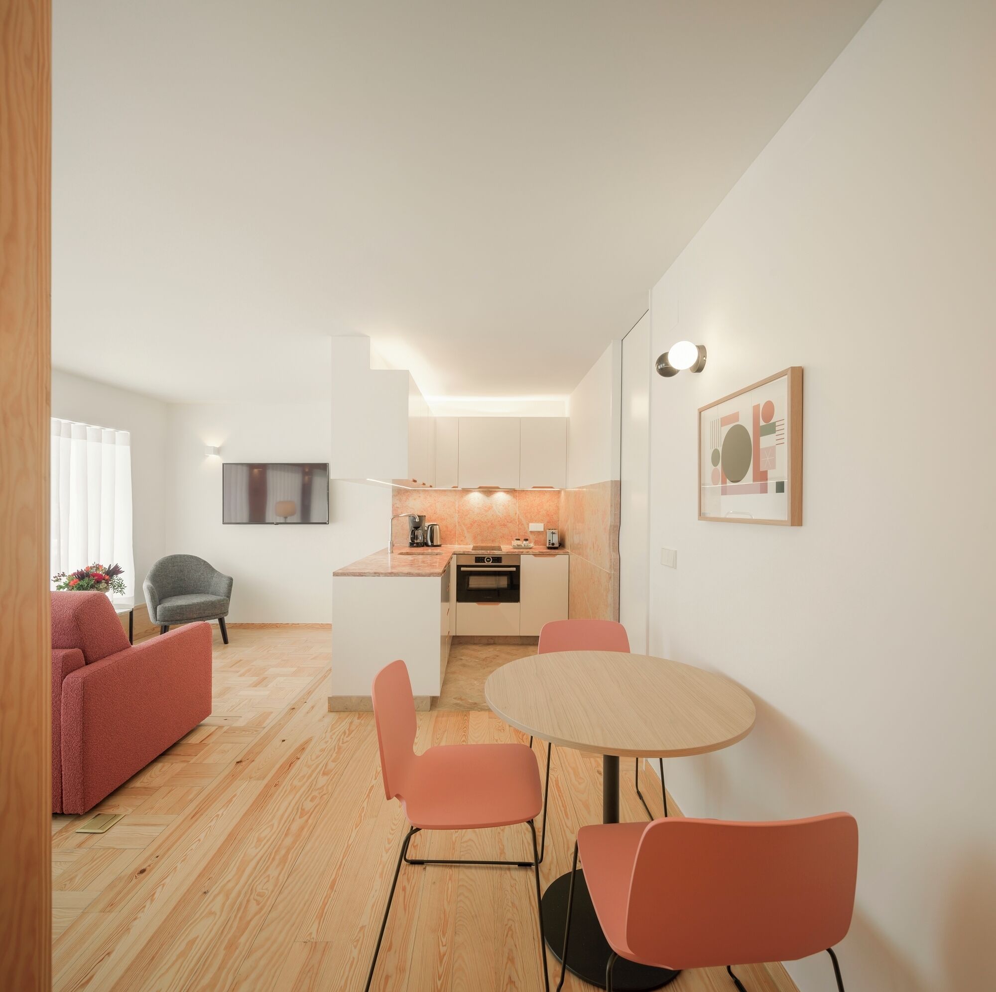 A modern apartment with a kitchen, dining area, and living space.