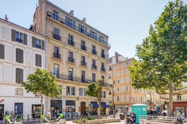 A multi-story building with balconies, a café, and a visible restroom.