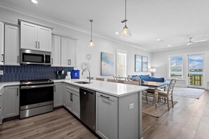 Enjoy cooking in this well-lit kitchen with a central island and outdoor view.