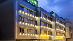 A hotel with a modern design, featuring multiple floors and a prominent sign indicating it is a B&B hotel. - B&B Hotel Lisboa Aeroporto (Loures)