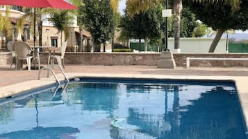 Outdoor pool, open 8:00 AM to 8:00 PM, pool umbrellas