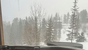 A hot tub with a view of a snowy forest. - Summit Trails Lodge: Cozy, Hot Tub, Trail Access (Lead)