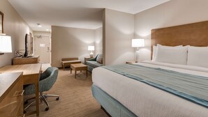A hotel room with a bed, desk, chair, and bedside tables. - Best Western Plus Desoto (Olive Branch)