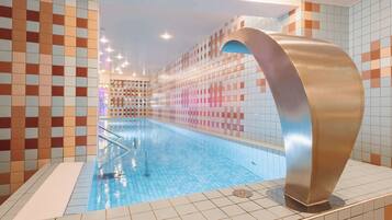 A swimming pool with tiled walls and a curved metallic structure.