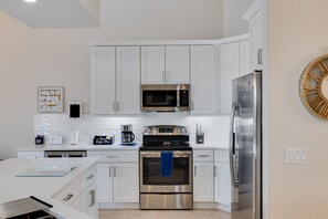 Fridge, microwave, coffee/tea maker, cookware/dishes/utensils