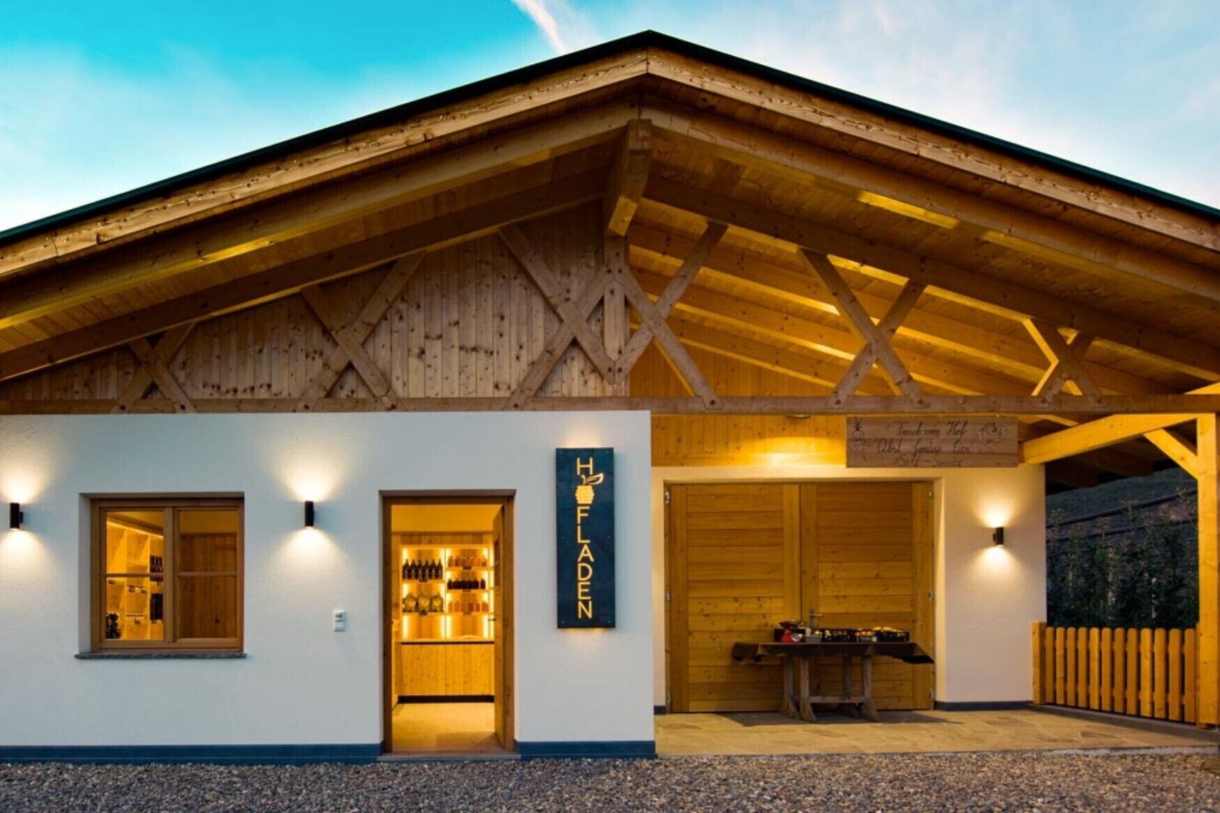 A wooden building with a sign reading 'Hof Fladen.'
