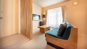 A modern hotel room with a wooden sofa, a small wooden table, a flat-screen TV, and a large window with curtains. - Hotel Rokune (Nara)