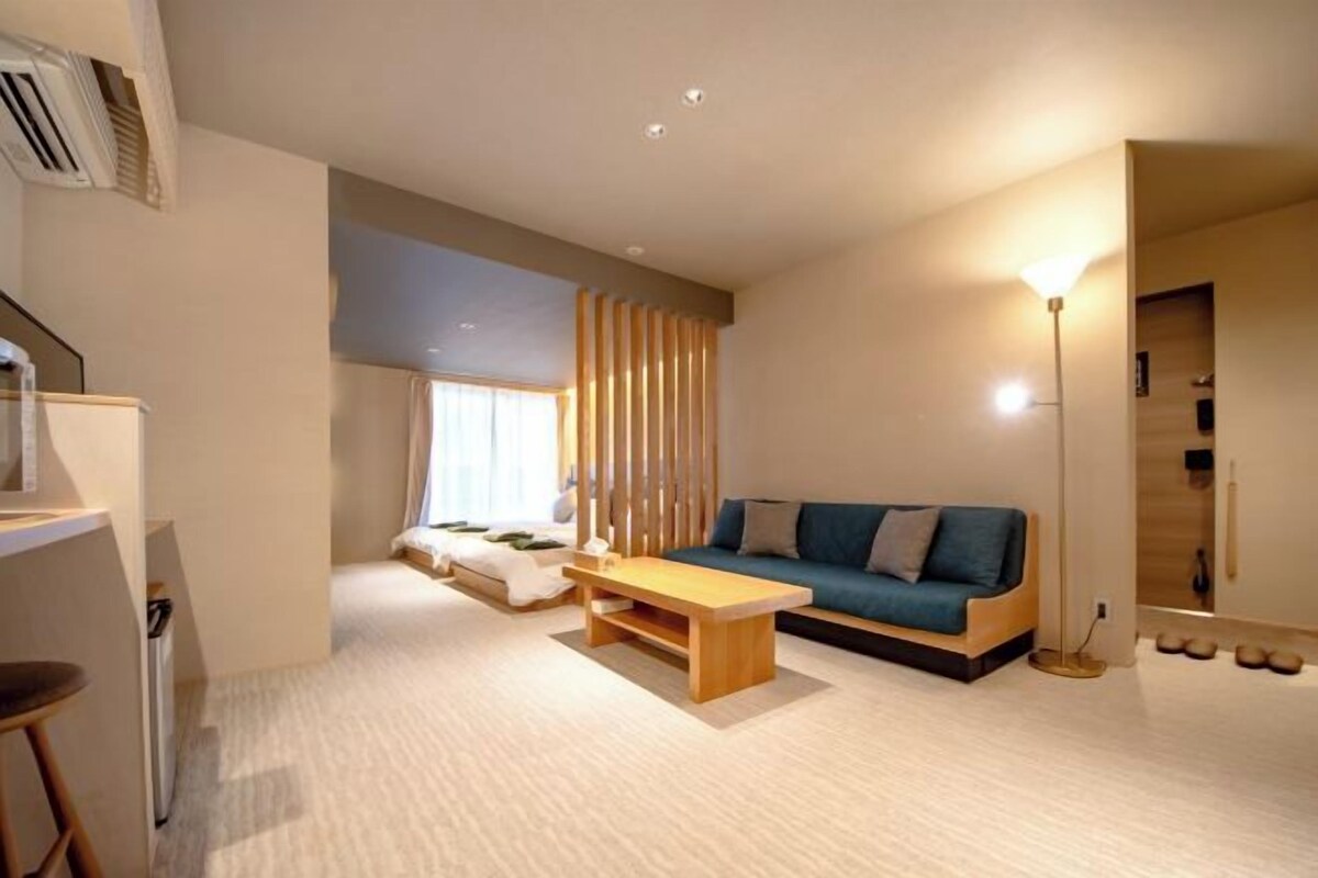 A modern living room with a sofa, a coffee table, and a floor lamp.