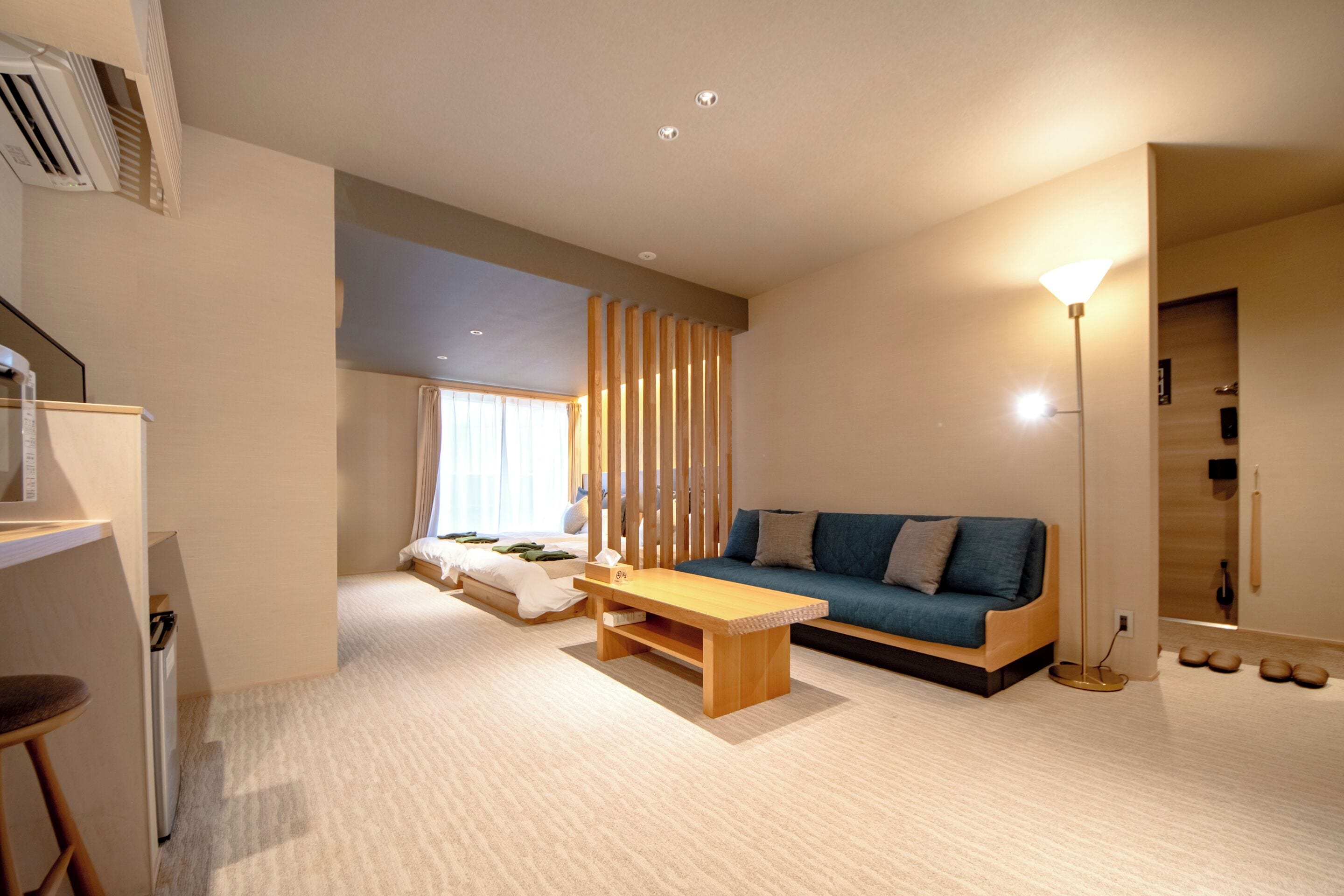 A modern living room with a sofa, coffee table, and a floor lamp.