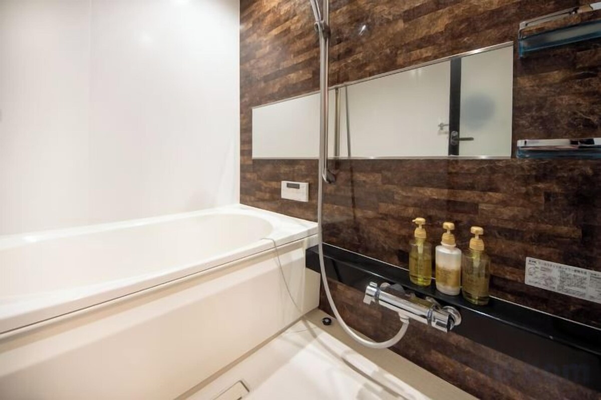 Bathroom | Separate bathtub and shower, free toiletries, hair dryer, slippers