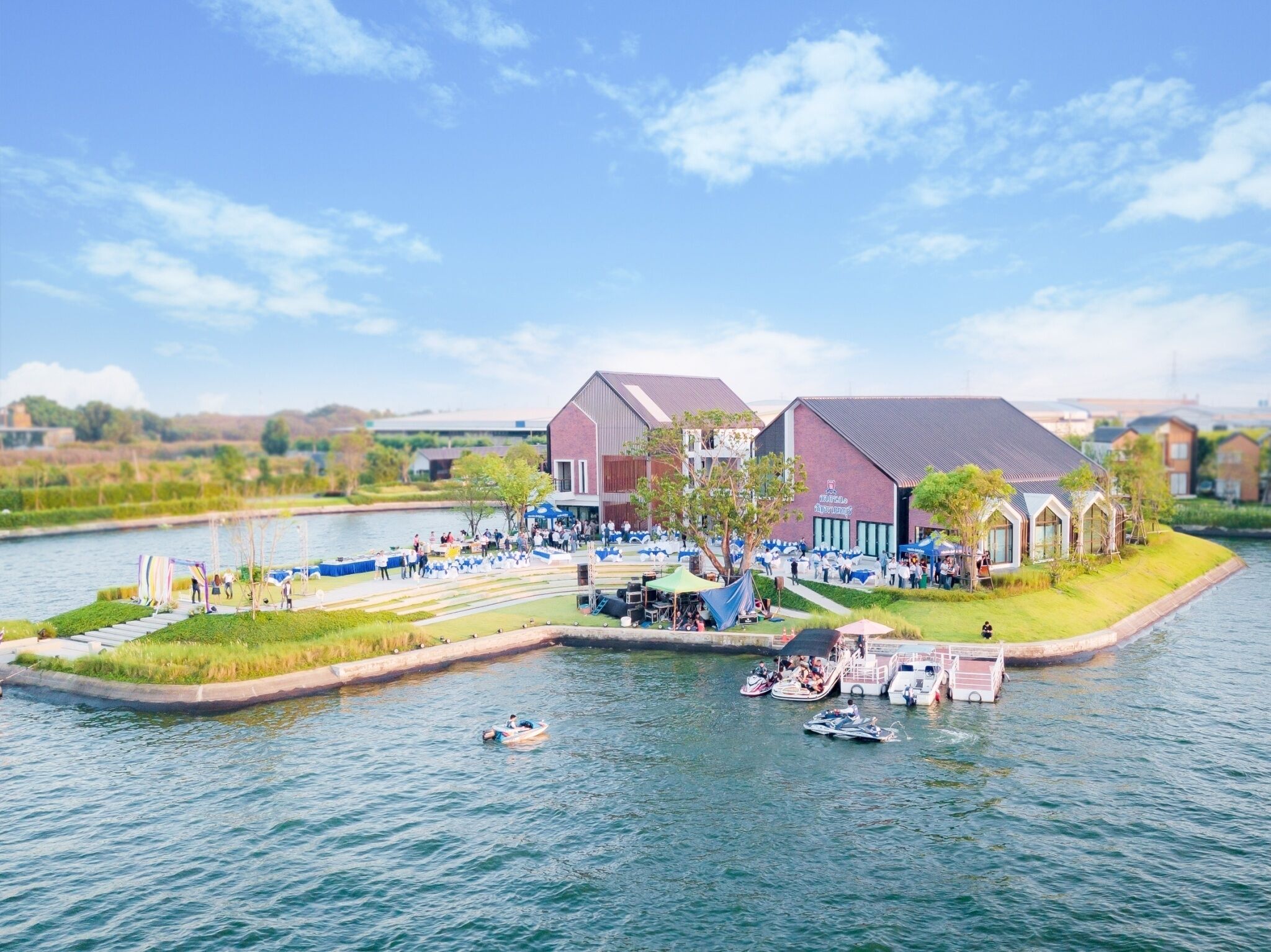 A riverside hotel with outdoor seating and boats.