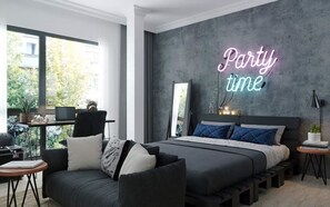 A modern bedroom with a large bed, a desk, and a neon sign that reads "Party time". - Manmo Home Plus Luong Su (Hanoi)
