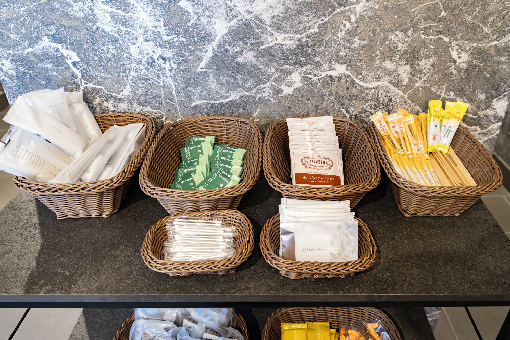 A display of various packaged goods in wicker baskets on a counter.